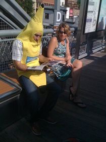 Woman waiting on train platform banana for scale