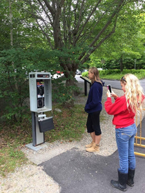 youths taking photo of extinct technology